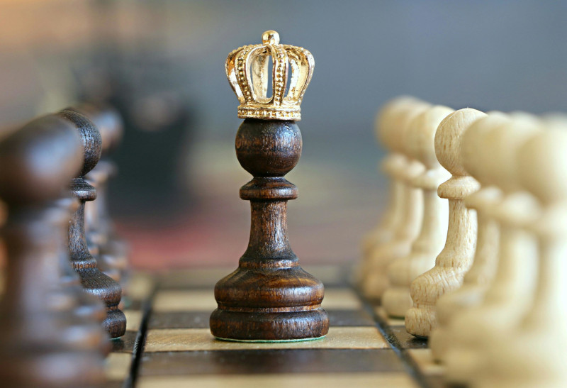 Chess pawn wearing a crown