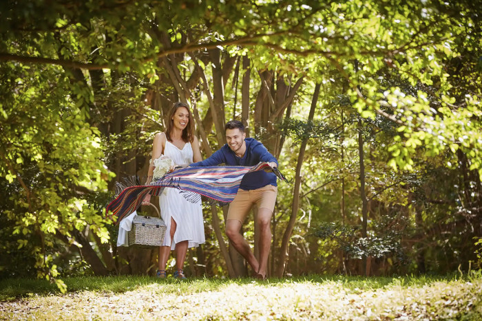 a couple setting up a picnic at Kholo Gardens