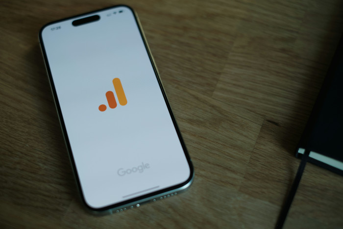 photo of a smartphone with google analytics app loading on it