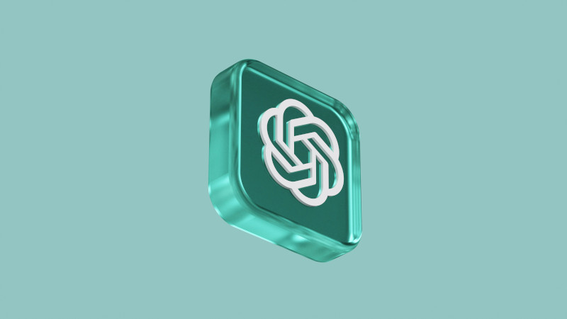  3D icon of the OpenAI logo in a transparent teal square, floating against a solid light teal background.